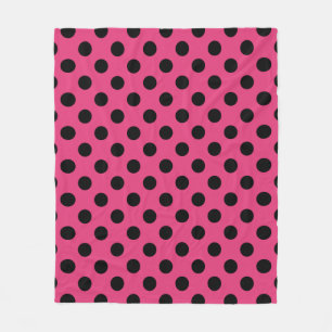 Black polka dots on fuchsia fleece blanket