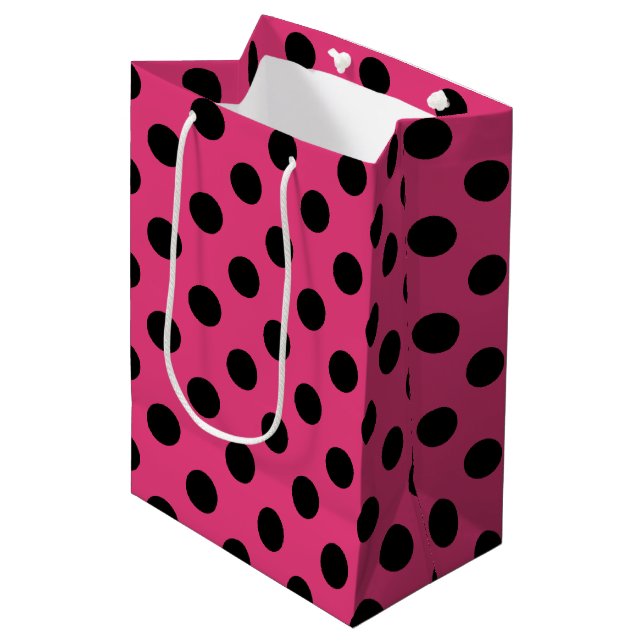 Black polka dots on fuchsia medium gift bag (Front Angled)
