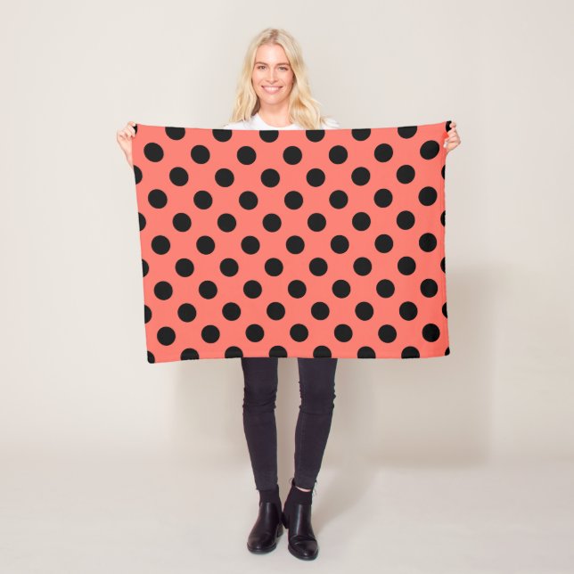 Black polka dots on living coral fleece blanket (In Situ)