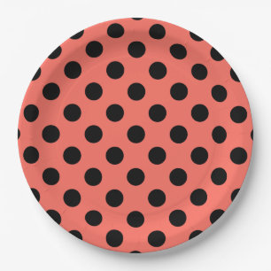 Black polka dots on living coral paper plate