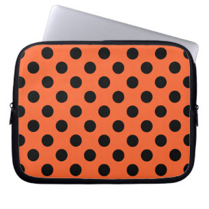 Black polka dots on orange laptop sleeve