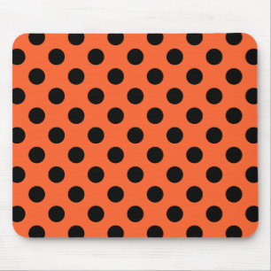 Black polka dots on orange mouse mat