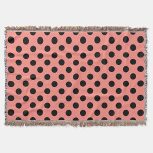 Black polka dots on peach throw blanket