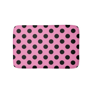 Black polka dots on pink bath mat