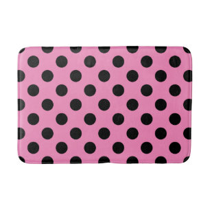 Black polka dots on pink bath mat