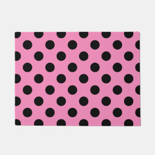 Black polka dots on pink doormat
