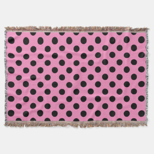 Black polka dots on pink throw blanket