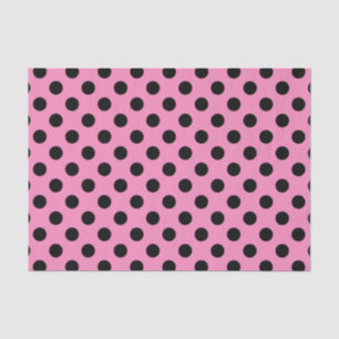 Black polka dots on pink tissue paper