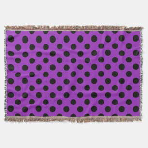 Black polka dots on purple throw blanket