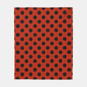 Black polka dots on red fleece blanket