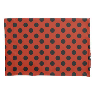 Black polka dots on red pillowcase