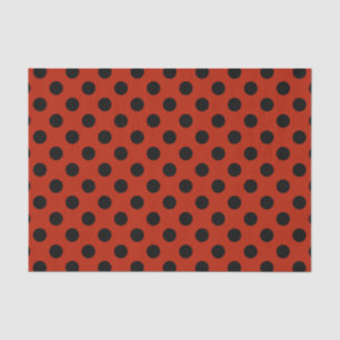 Black polka dots on red tissue paper