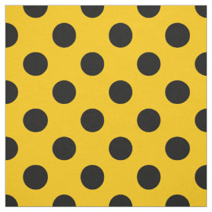 Black polka dots on yellow fabric