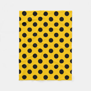 Black polka dots on yellow fleece blanket