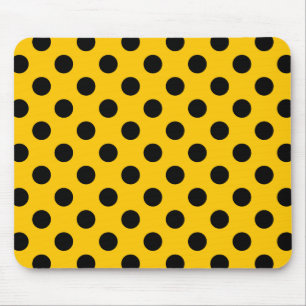 Black polka dots on yellow mouse mat