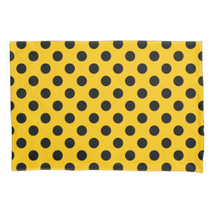 Black polka dots on yellow pillowcase