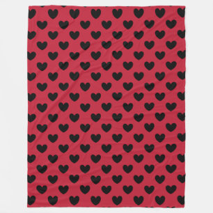 Black polka hearts on red fleece blanket
