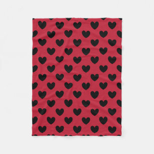 Black polka hearts on red fleece blanket