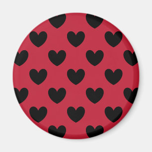 Black polka hearts on red magnet