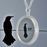 Black Raven Silhouette with Initials Silver Plated Necklace<br><div class="desc">A solitary Raven perched on a wire in black silhouette against a grey sky on this gothic pendant necklace.Throughout history and world cultures, the raven is found in lore, mythology and literature. The raven's symbolism is varied. It's great for bird lovers and fans of Edgar Allen Poe, the macabre and...</div>