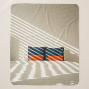 Black red and white plaid textile on white bed sherpa blanket