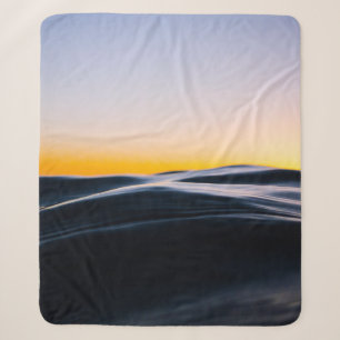 BLACK SAND UNDER ORANGE SKY DURING SUNSET SHERPA BLANKET