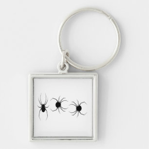 Black spiders on white key ring