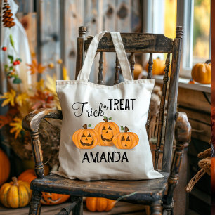 Black trick or treat typography Smiling Pumpkins Tote Bag