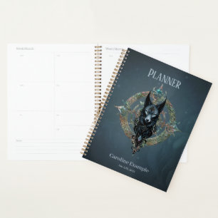 Black wolfs head with piercing blue eyes, planner