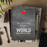 Blackboard teacher name red apple quote planner<br><div class="desc">White typography script quote "Your teacher changes the world one child at a time" on a dark grey charcoal chalkboard background and a small red apple.             Personalise this planner with your best teacher's name and make it a thoughtful keepsake gift to express your gratitude!</div>