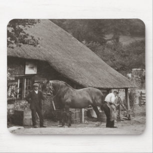 Blacksmith shoeing a horse mouse mat