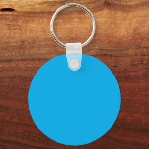 Blank Blue Circular Keychain Tag on Wood Surface