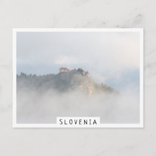 Bled castle surrounded by clouds postcard