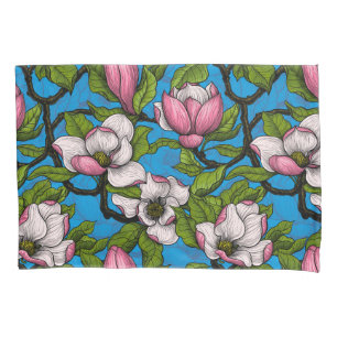 Blooming magnolia on blue pillowcase
