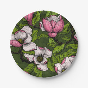 Blooming magnolia on dark green paper plate