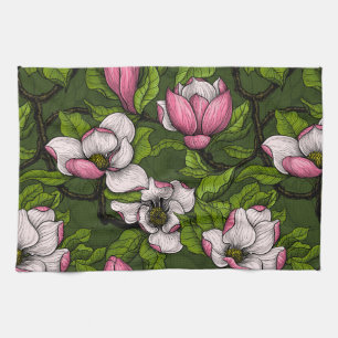 Blooming magnolia on dark green tea towel