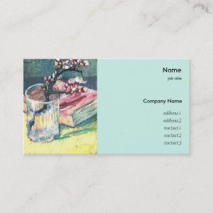 Blossoming almond branch in a glass with a book business card