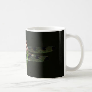 Blue and black Dragonfly on green and red grass Coffee Mug