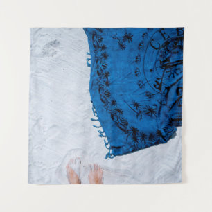 Blue and black floral scarf on white sand tapestry