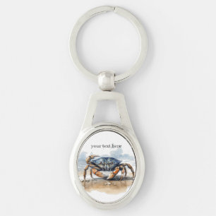 blue and orange crab walking on the beach  key ring
