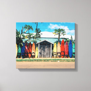 blue and white house surrounded by surfboards duri canvas print
