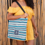 Blue and White Multi Stripe Monogram Tote Bag<br><div class="desc">Our striped monogram tote bag features a variegated horizontal stripe pattern in cool summer blues,  with your single initial monogram in coordinating navy blue. If not monogramming,  simply delete the sample initial and click "clear" to remove the blue square.</div>