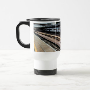 Blue and white train , at the railway travel mug
