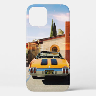 Blue car parked beside brown concrete building in iPhone 12 case