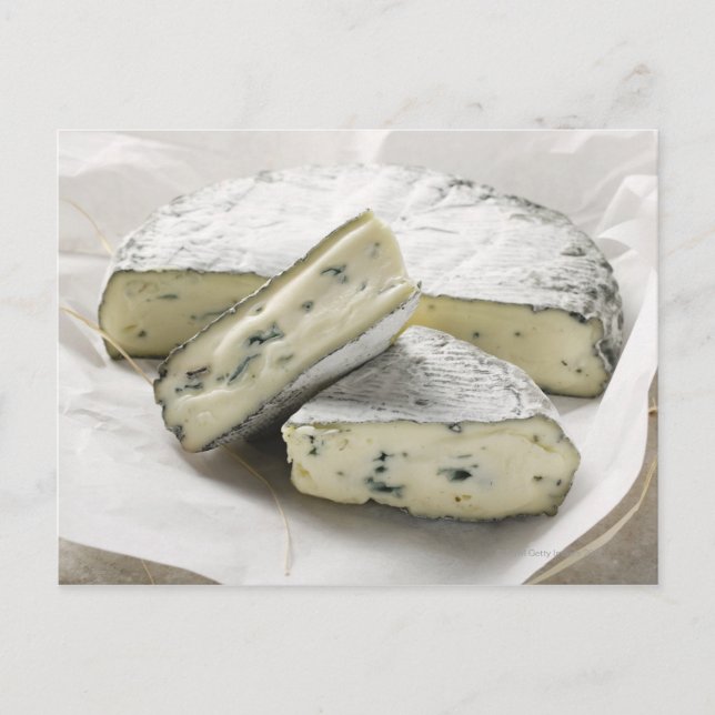 Blue cheese with pieces cut on paper postcard