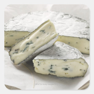 Blue cheese with pieces cut on paper square sticker