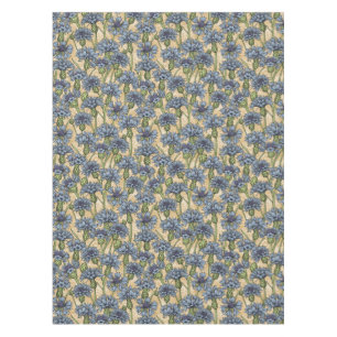 Blue cornflowers, wild flowers on honney yellow tablecloth