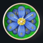 Blue Daisy Flower on Green Beautiful Wall Clock<br><div class="desc">This pretty floral clock has an original stylised flower on it, in a daisy style and coloured blue. The yellow-orange clock numbers mark the time on the twelve petals. The background is done in an abstract mottled green, resembling grass. This is a bright, bold clock for a gardener or any...</div>