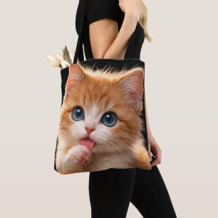 Blue-Eyed Paw licking Kitten Tote Bag