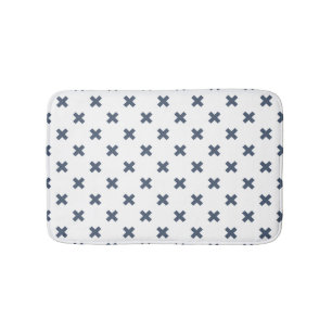 Blue-grey cross stitches on white bath mat